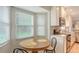 Charming kitchen nook featuring a round table, comfortable seating, and natural light from large windows at 7142 Bright Creek Dr # 35, Sarasota, FL 34231
