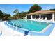 Sparkling community pool with lounge chairs, and shade for a refreshing outdoor experience at 7142 Bright Creek Dr # 35, Sarasota, FL 34231