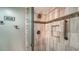 Walk-in shower features decorative tile accents, storage niche, and glass enclosure at 7142 Bright Creek Dr # 35, Sarasota, FL 34231