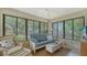 Bright and airy sunroom with ample seating, perfect for relaxing and enjoying the view to the backyard at 7142 Bright Creek Dr # 35, Sarasota, FL 34231