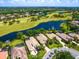 Gorgeous aerial view of the neighborhood featuring well-manicured lawns, lake, and golf course at 7229 Lake Forest Gln, Lakewood Ranch, FL 34202