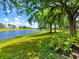 Scenic backyard with mature trees and lush landscaping overlooks the tranquil golf course and shimmering pond at 7229 Lake Forest Gln, Lakewood Ranch, FL 34202