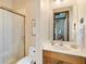 Well-lit bathroom features a glass door shower and a vanity with sink at 7229 Lake Forest Gln, Lakewood Ranch, FL 34202