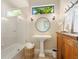 Bright bathroom featuring a pedestal sink, modern fixtures, and a glass-enclosed shower at 7229 Lake Forest Gln, Lakewood Ranch, FL 34202