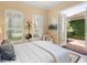 Inviting bedroom with wood floors, plantation shutters, and backyard access through French doors at 7229 Lake Forest Gln, Lakewood Ranch, FL 34202