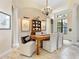 Elegant dining room with chandelier, decorative columns, and rustic wood table at 7229 Lake Forest Gln, Lakewood Ranch, FL 34202