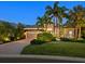 Charming one-story home with lush landscaping, a brick driveway, and a two car garage at 7229 Lake Forest Gln, Lakewood Ranch, FL 34202