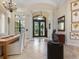 Elegant foyer with soaring ceilings, tile flooring, and exquisite chandelier lighting at 7229 Lake Forest Gln, Lakewood Ranch, FL 34202