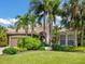 Inviting home showcasing lush landscaping, a paver driveway, and a warm, neutral color palette at 7229 Lake Forest Gln, Lakewood Ranch, FL 34202