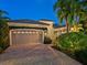 A view of the exterior of the property including a two car garage and brick driveway at 7229 Lake Forest Gln, Lakewood Ranch, FL 34202