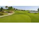 Scenic golf course view with lush green fairways, mature trees, and a tranquil lake at 7229 Lake Forest Gln, Lakewood Ranch, FL 34202