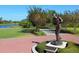 Golf course featuring a statue on a brick paved court with landscaped surroundings and water view at 7229 Lake Forest Gln, Lakewood Ranch, FL 34202