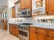 Bright kitchen featuring stainless steel range, custom cabinets, and white subway tile backsplash at 7229 Lake Forest Gln, Lakewood Ranch, FL 34202