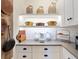 White kitchen features decorative shelving, lighting, and butcher block countertops at 7229 Lake Forest Gln, Lakewood Ranch, FL 34202