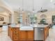 Open kitchen with large island and stainless appliances opens to the living spaces at 7229 Lake Forest Gln, Lakewood Ranch, FL 34202
