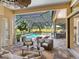 Inviting screened lanai with beautiful seating, pool, golf course, and outdoor kitchen at 7229 Lake Forest Gln, Lakewood Ranch, FL 34202