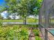 Lush backyard garden with stepping stones, bird bath, and views of the golf course and pond at 7229 Lake Forest Gln, Lakewood Ranch, FL 34202
