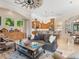 Open-concept living room and kitchen with wood cabinets, stainless steel appliances and decorative ceiling fan at 7229 Lake Forest Gln, Lakewood Ranch, FL 34202