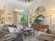 Bright living room with high ceilings, a ceiling fan, and a sliding glass door leading to the outdoors at 7229 Lake Forest Gln, Lakewood Ranch, FL 34202