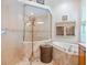 Bright bathroom featuring tiled floors, a soaking tub, a glass-enclosed shower and neutral colors at 7229 Lake Forest Gln, Lakewood Ranch, FL 34202