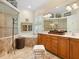 Bright bathroom with tiled floors, a soaking tub, and a glass-enclosed shower at 7229 Lake Forest Gln, Lakewood Ranch, FL 34202