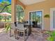 Outdoor kitchen in screened lanai with seating, grill, and view to the pool at 7229 Lake Forest Gln, Lakewood Ranch, FL 34202