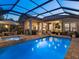 Beautiful outdoor pool area with a spa, outdoor dining area, lounge chairs, and screened enclosure at 7229 Lake Forest Gln, Lakewood Ranch, FL 34202