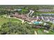 Stunning aerial view of a community featuring a clubhouse, pool, golf course, and lush landscaping at 7705 Grand Estuary Trl # 206, Bradenton, FL 34212