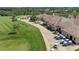 Aerial view of clubhouse with golf course, cart parking, and well manicured landscaping at 7705 Grand Estuary Trl # 206, Bradenton, FL 34212