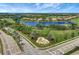 Aerial view of a beautiful community featuring a serene lake, lush greenery, and well-maintained landscaping at 7705 Grand Estuary Trl # 206, Bradenton, FL 34212