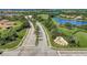 Aerial view of the community entrance with a water feature, lush landscaping, and well-maintained roads at 7705 Grand Estuary Trl # 206, Bradenton, FL 34212
