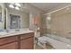 Well-maintained bathroom with a single sink vanity, a glass enclosed tub and a toilet at 7705 Grand Estuary Trl # 206, Bradenton, FL 34212
