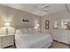 Calm bedroom featuring a white bed, white dressers, and beach-themed decor at 7705 Grand Estuary Trl # 206, Bradenton, FL 34212