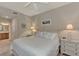 Cozy bedroom featuring a white bed and dressers with beach-themed decor; bathroom in background at 7705 Grand Estuary Trl # 206, Bradenton, FL 34212