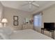 Bright bedroom with a white bed, dresser, and a window with sheer curtains, and a black TV at 7705 Grand Estuary Trl # 206, Bradenton, FL 34212