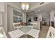 Cozy dining area with a round glass table and white chairs, offering a view of the living space at 7705 Grand Estuary Trl # 206, Bradenton, FL 34212
