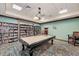 Relax in this game room with a billiard table and bookshelves, perfect for quiet moments or entertaining friends at 7705 Grand Estuary Trl # 206, Bradenton, FL 34212