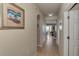 Inviting hallway with tile flooring, leading to an open living space with seating at 7705 Grand Estuary Trl # 206, Bradenton, FL 34212