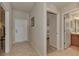 Inviting hallway with tile flooring, leading to bedrooms and bathroom at 7705 Grand Estuary Trl # 206, Bradenton, FL 34212