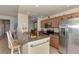 Modern kitchen featuring stainless steel appliances, granite countertops, and a breakfast bar with seating at 7705 Grand Estuary Trl # 206, Bradenton, FL 34212