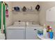 A tidy laundry room with a washer, dryer and shelf, designed for convenience at 7705 Grand Estuary Trl # 206, Bradenton, FL 34212
