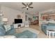 Open living space featuring comfortable seating, a ceiling fan, and dining area access at 7705 Grand Estuary Trl # 206, Bradenton, FL 34212