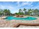 Enjoy the tranquil atmosphere of this pool featuring a central island with lush landscaping, surrounded by inviting lounge chairs at 7705 Grand Estuary Trl # 206, Bradenton, FL 34212