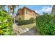 Exterior rear view highlighting the manicured hedges and well-maintained lawn at 7983 Limestone Ln # 14-201, Sarasota, FL 34233