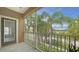 Inviting, covered balcony with palm tree views, providing a tranquil outdoor living space at 7983 Limestone Ln # 14-201, Sarasota, FL 34233