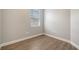 This bedroom features a window and wood-look flooring at 7983 Limestone Ln # 14-201, Sarasota, FL 34233