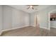Large bedroom with wood floors, ceiling fan, and doorways to the bathroom and other rooms at 7983 Limestone Ln # 14-201, Sarasota, FL 34233