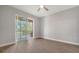 Bright bedroom featuring wood floors and a sliding glass door to a screened balcony at 7983 Limestone Ln # 14-201, Sarasota, FL 34233