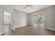 Spacious bedroom boasts wood floors and access to screened lanai through sliding glass doors at 7983 Limestone Ln # 14-201, Sarasota, FL 34233