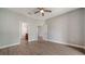Bedroom featuring wood floors, a ceiling fan, and access to the bathroom and other rooms at 7983 Limestone Ln # 14-201, Sarasota, FL 34233